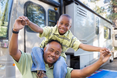 dad and son in front of rv